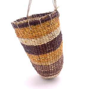 pandanus dilly bag, a cylindrical bag with rows of different coloured pandanus in brown, yellow and natural with a natural string handle