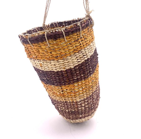 pandanus dilly bag, a cylindrical bag with rows of different coloured pandanus in brown, yellow and natural with a natural string handle