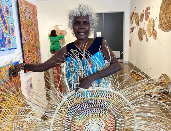 Betty Milikens, Aboriginal artist, with pandanus mats at Songlines Darwin