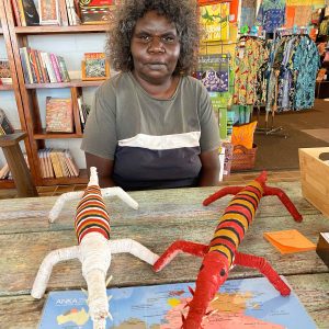 Gloreen Campion with two of her crocodile sculptures made from natural fibres at Songlines Darwin