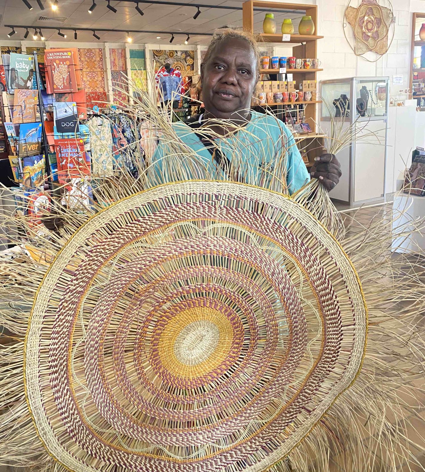 Wendy Namarnyilk and mat made from Pandanus spiralis fibres at Songlines Gallery Darwin