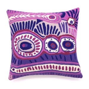 Wool chain stitch cushion cover designed by Aboriginal artist Murdie Nampijinpa Morris of Warlukurlangu Artists and made by Better World Arts. Available from Songlines Gallery in Darwin